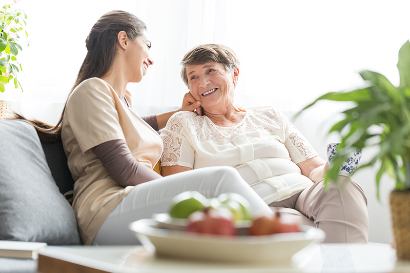 woman talking with elderly mother woman talking with elderly mother