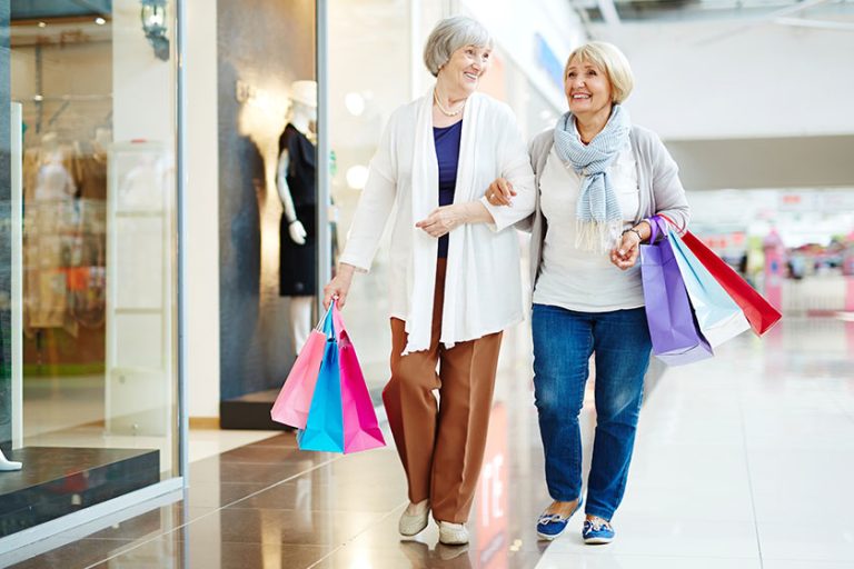 Women with paper bags in shopping center