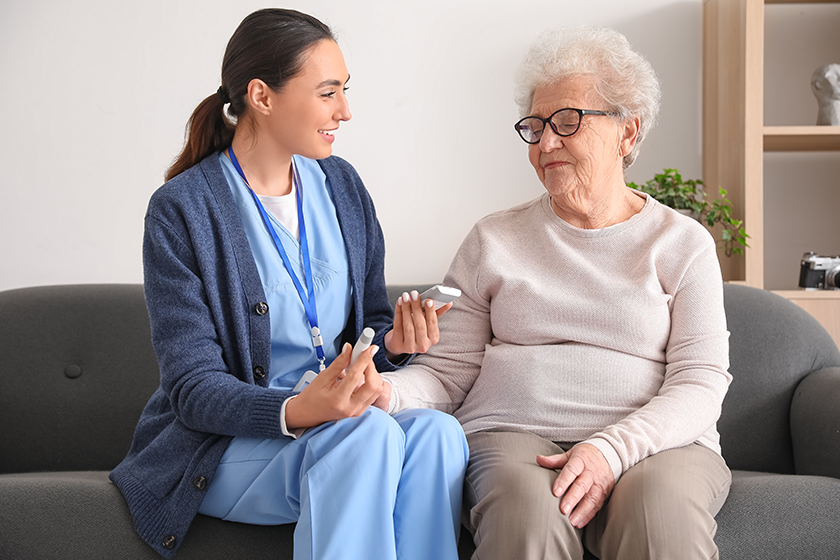 young caregiver measuring sugar level