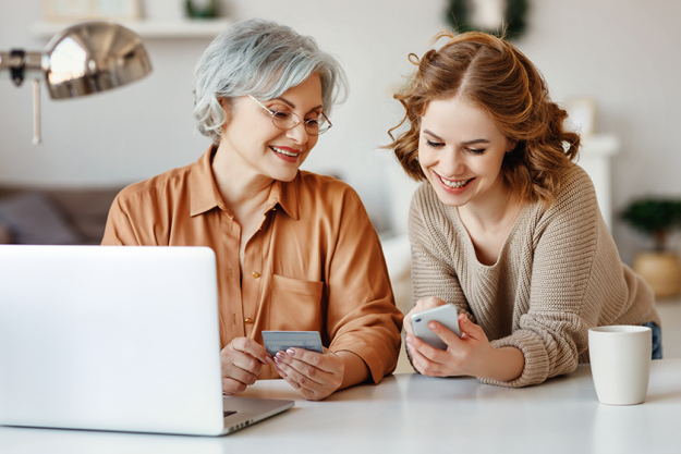 young daughter smartphone smiling showing laptop