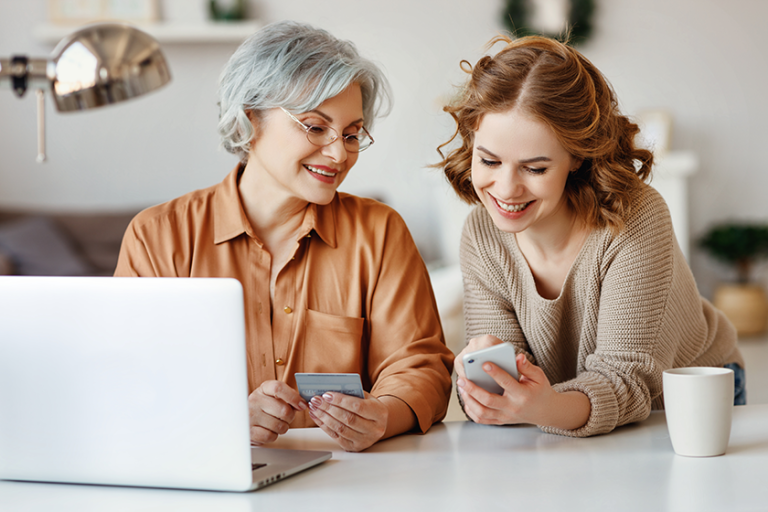 young daughter smartphone smiling showing laptop