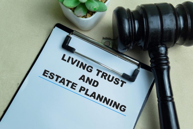 Concept of Living Trust and Estate Planning write on paperwork isolated on wooden background. Concept of Living Trust and Estate Planning write on paperwork isolated on wooden background.