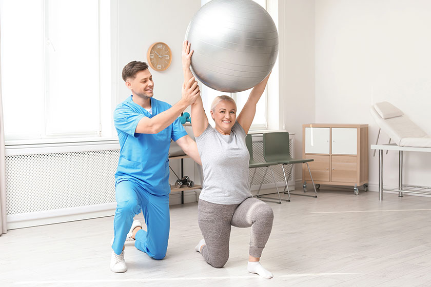 Physiotherapist working with patient in clinic rehabilitation therapy Physiotherapist working with patient in clinic rehabilitation therapy