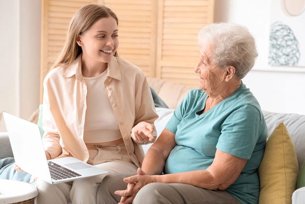 Senior woman her granddaughter using laptop home Senior woman her granddaughter using laptop home