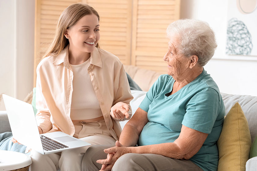 Senior woman her granddaughter using laptop home Senior woman her granddaughter using laptop home