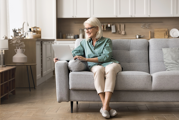elderly 60s woman retirement using laptop