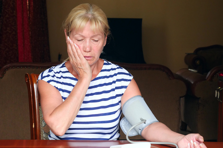elderly woman measuring blood pressure
