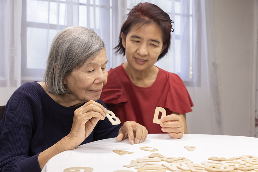 elderly woman playing alphabet games