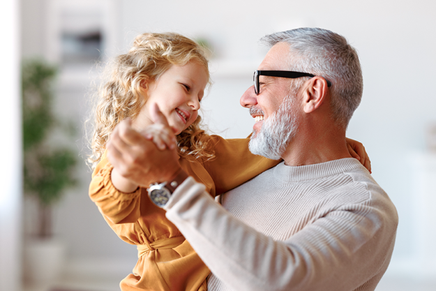 elegant loving caring grandfather looking his cute little granddaughter