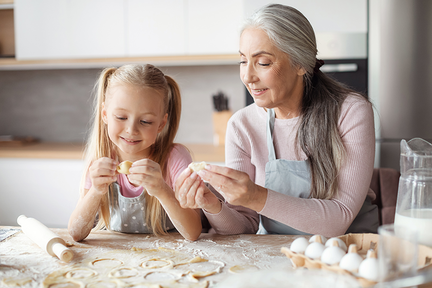 glad european little girl old grandmother aprons make cookies