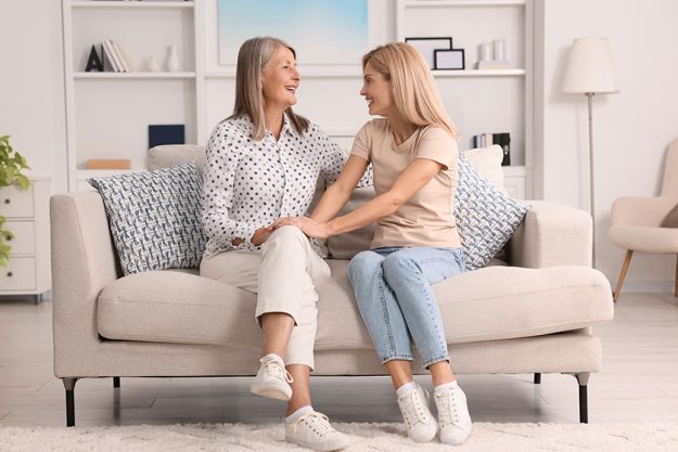 Happy mature mother her daughter spending time together home