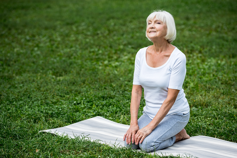 happy senior woman sitting meditation pose happy senior woman sitting meditation pose