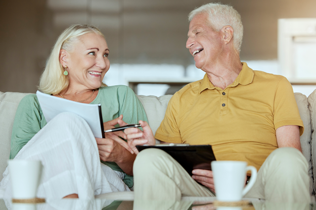 mature couple home happy paperwork mature couple home happy paperwork