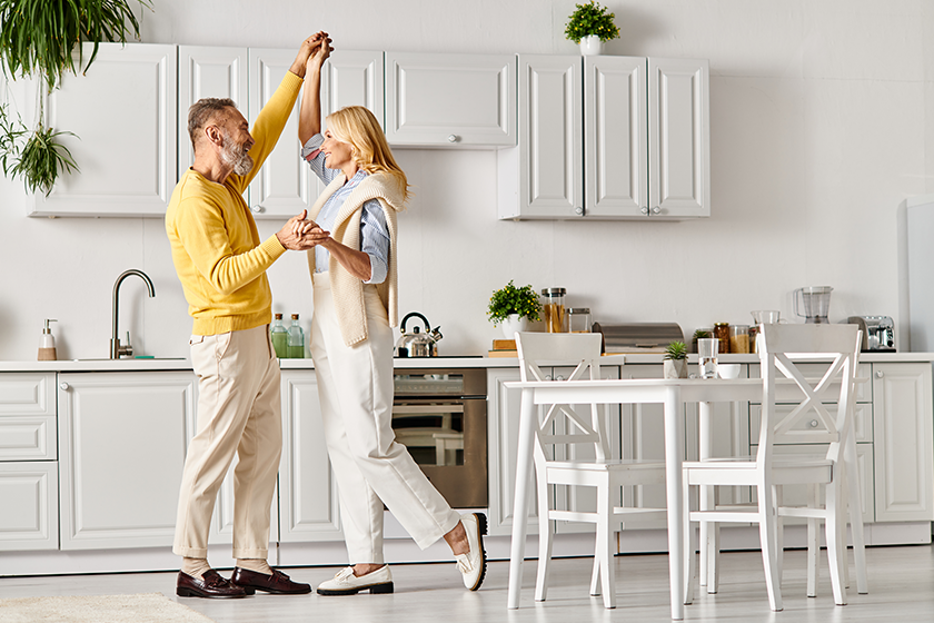 mature loving couple cozy homewear dancing