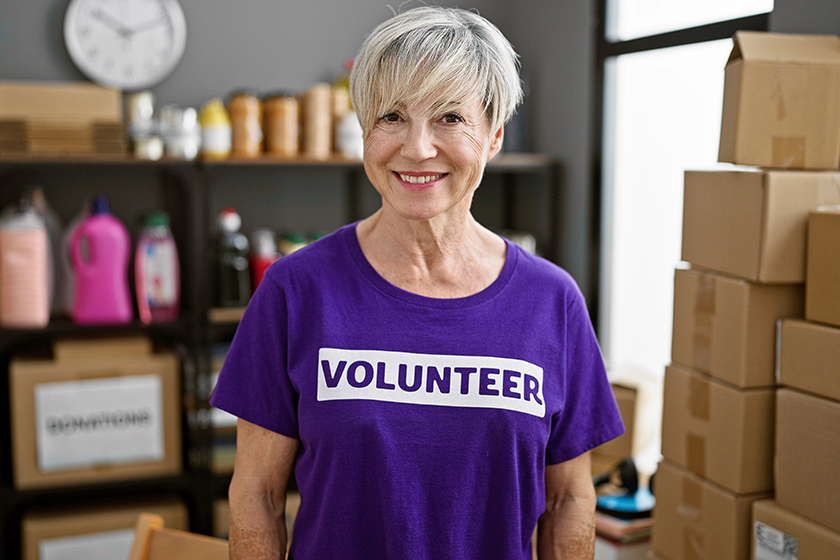 mature woman grey hair wearing volunteer shirt