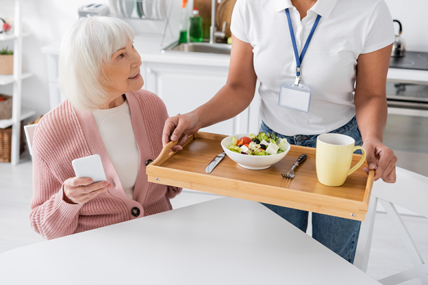 multiracial social worker holding tray lunch multiracial social worker holding tray lunch