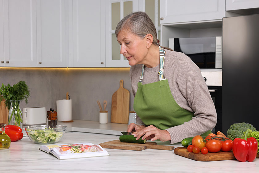 Senior woman cooking recipe book kitchen Senior woman cooking recipe book kitchen