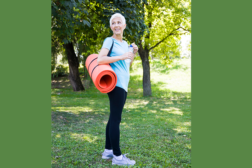 senior woman holds fitness mat senior woman holds fitness mat