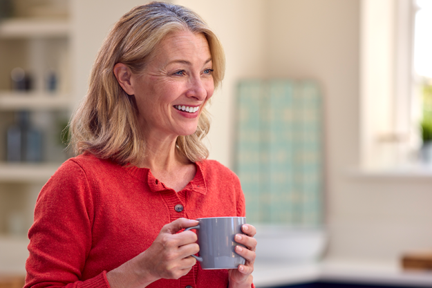 smiling mature woman standing kitchen smiling mature woman standing kitchen