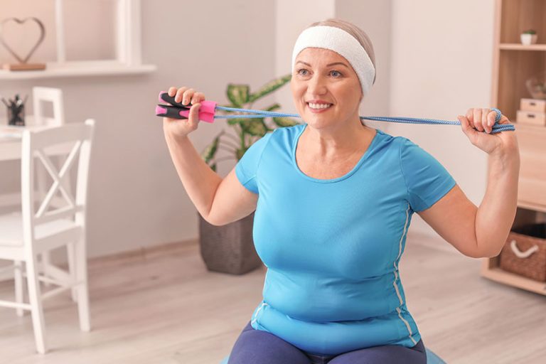 Sporty mature woman training home