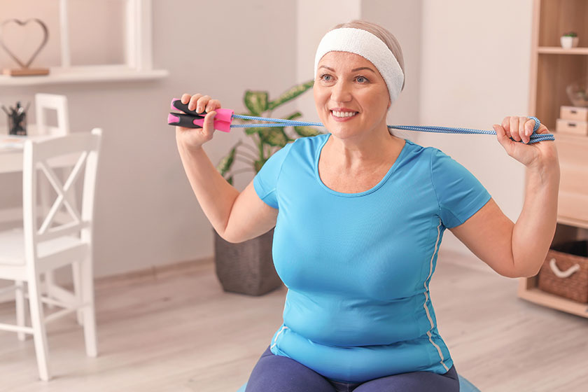 Sporty mature woman training home