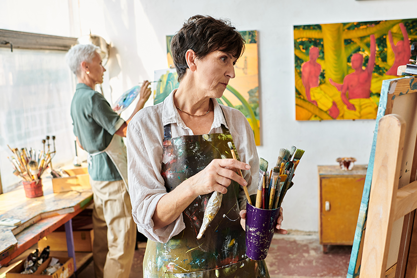 thoughtful mature woman set paintbrushes female friend art workshop thoughtful mature woman set paintbrushes female friend art workshop
