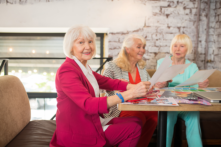 three well dressed aged ladies discussing a new collection of dresses three well dressed aged ladies discussing a new collection of dresses