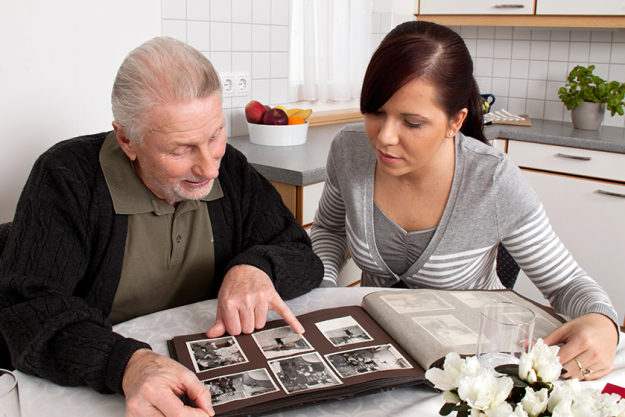 woman looks at a photo album with seniors