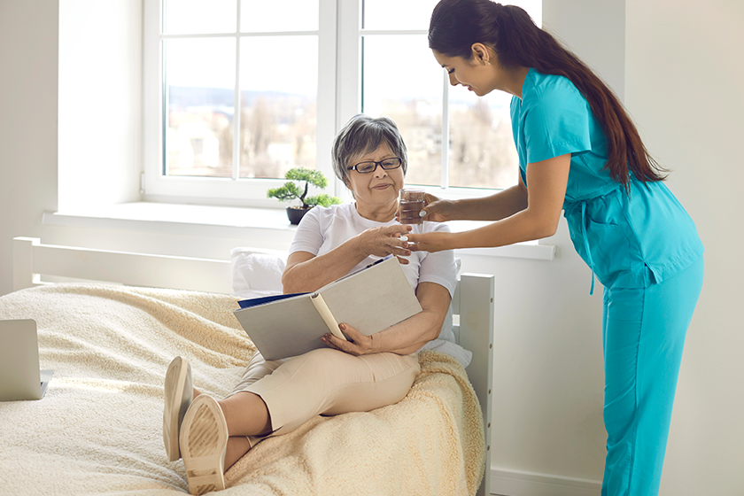 woman nurse giving prescribed pills and glass of water woman nurse giving prescribed pills and glass of water