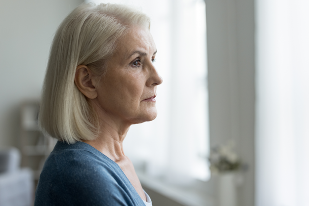 close portrait serious upset older woman looking out close portrait serious upset older woman looking out