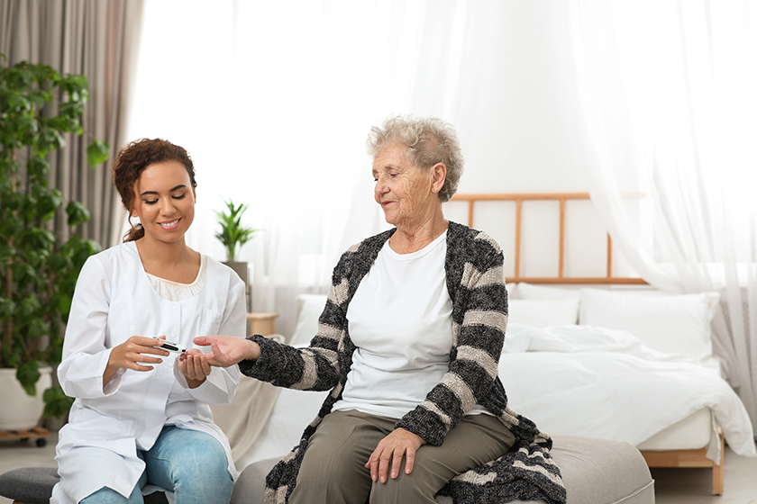 doctor measuring patients blood sugar level doctor measuring patients blood sugar level