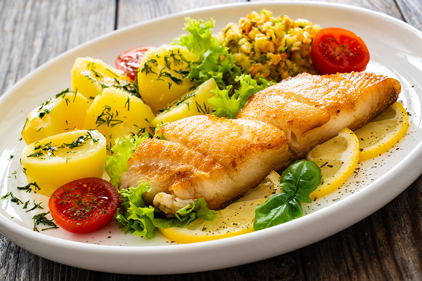 fried codfish loin boiled potatoes cabbage salad served