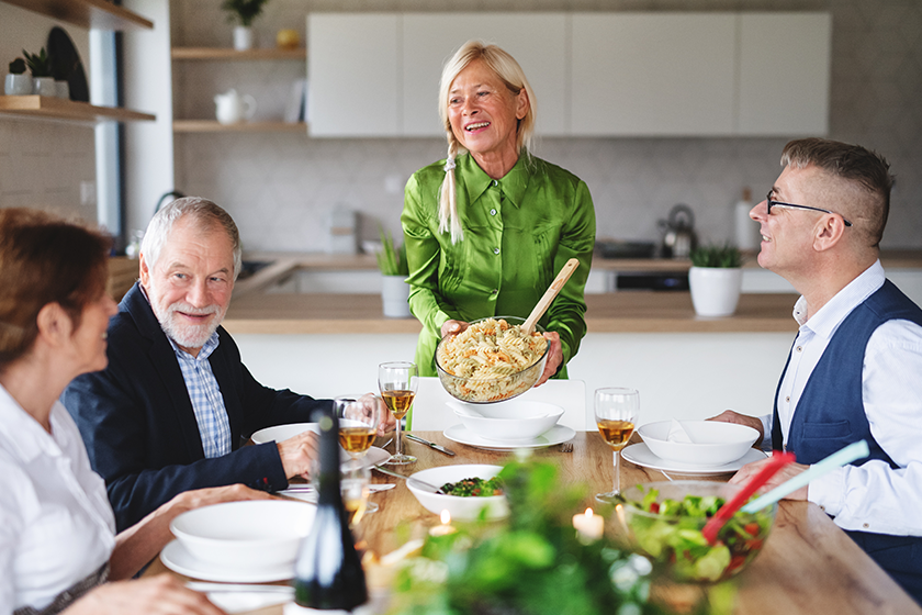 group of senior friends at dinner party at home group of senior friends at dinner party at home