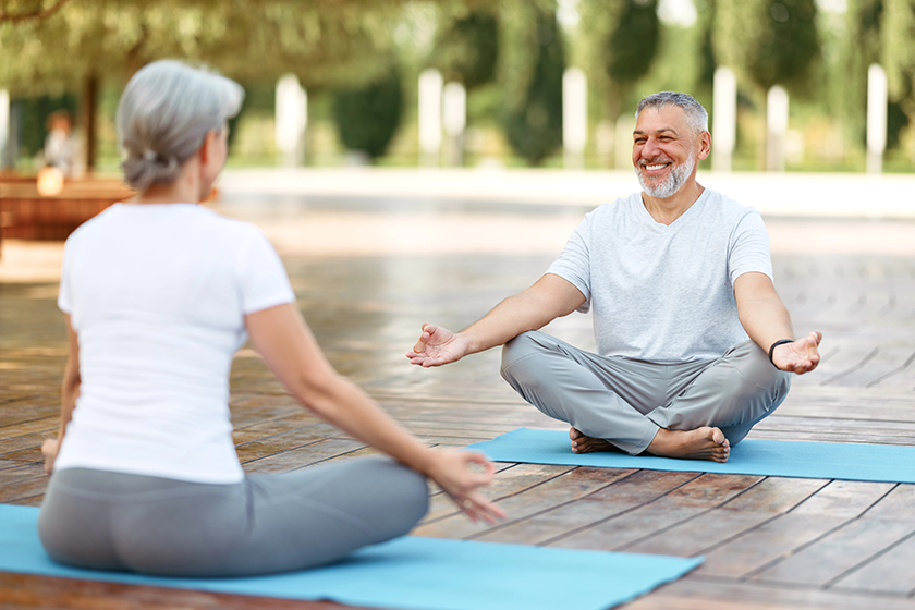 Senior meditating outdoors to stay young and healthy through mindfulness

