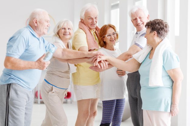 Team,Of,Happy,Active,Seniors,Gathering,Hands,Together,Before,The Team,Of,Happy,Active,Seniors,Gathering,Hands,Together,Before,The