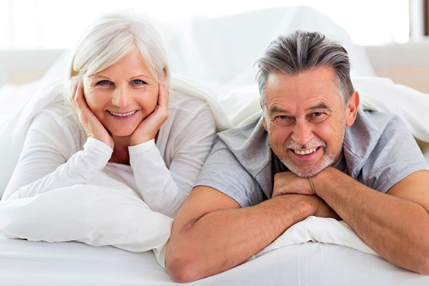 senior couple lying in bed together
