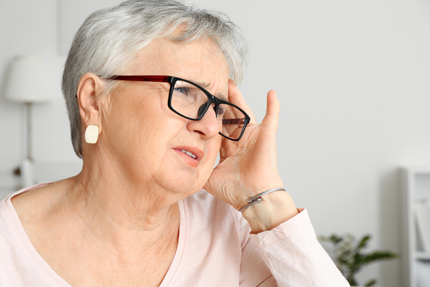 senior woman suffering from headache