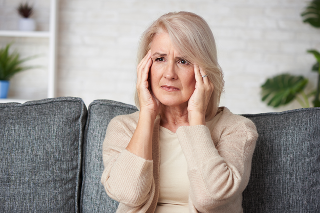 senior woman suffering headache depression