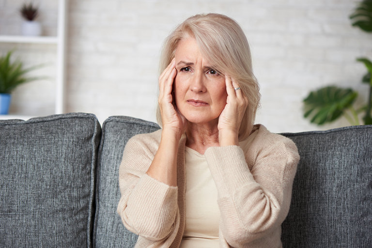 senior woman suffering headache depression
