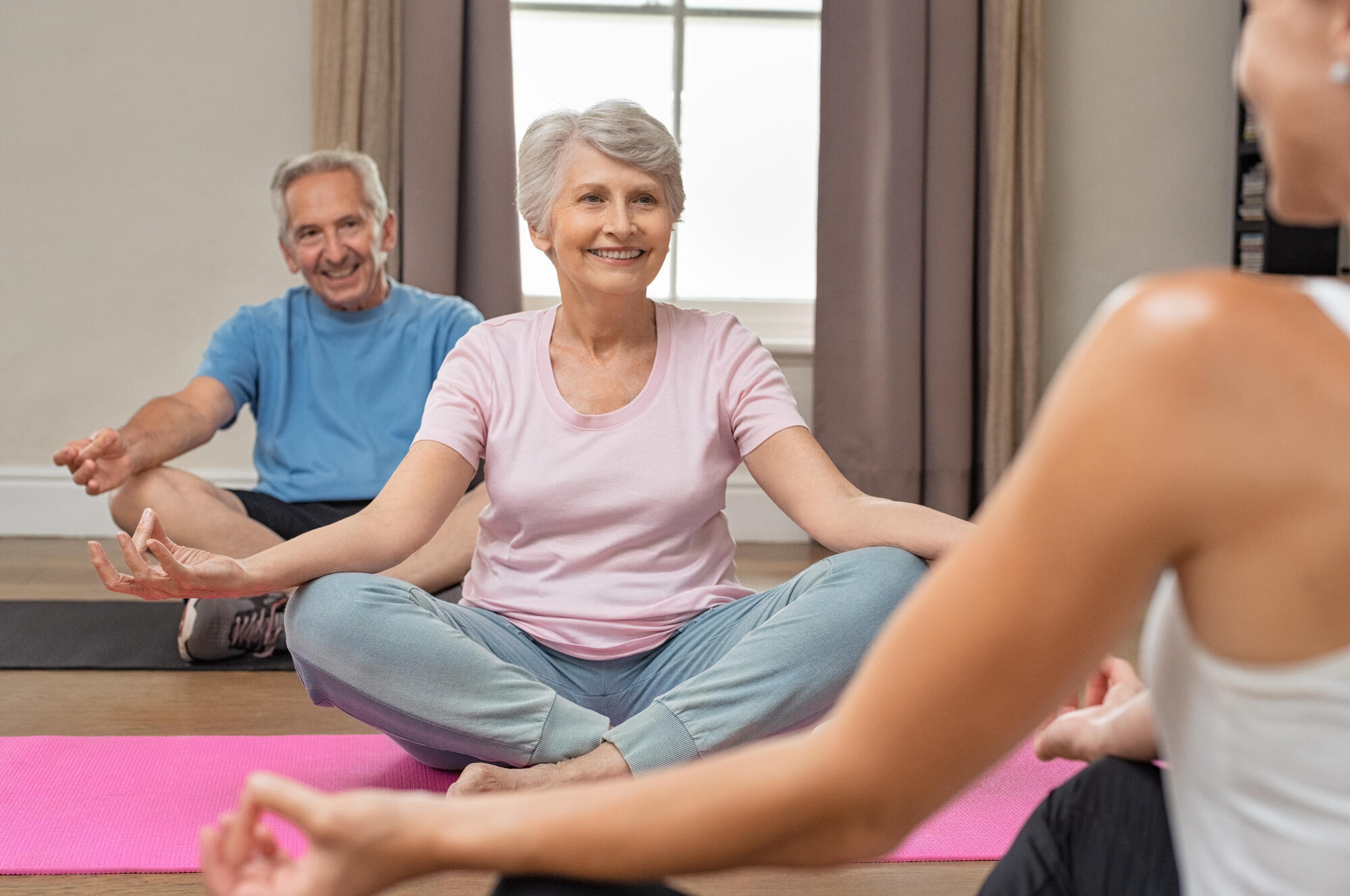 Senior,Couple,With,Trainer,Sitting,In,Lotus,Position,Meditating.,Instructor