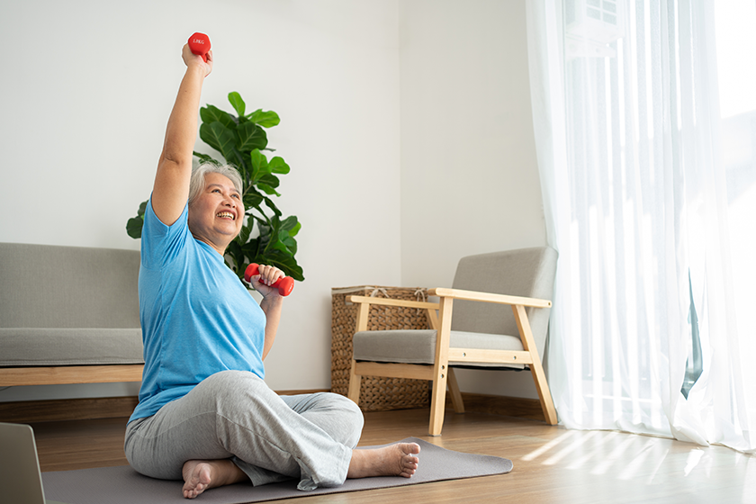 asian senior woman lifting dumbbell