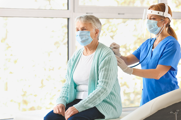 doctor examining senior woman