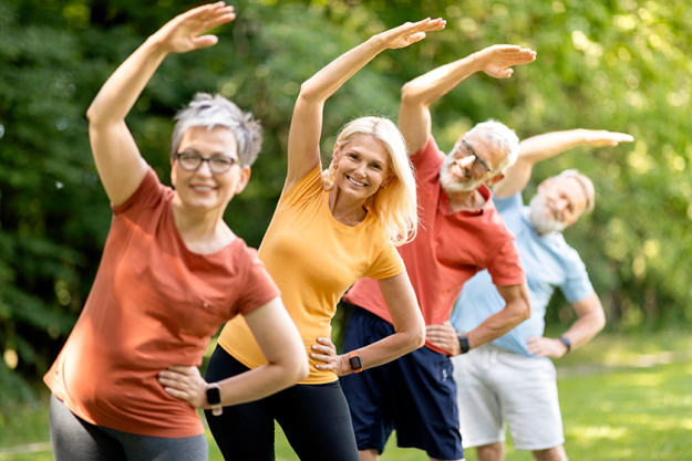 group sporty mature people doing stretching