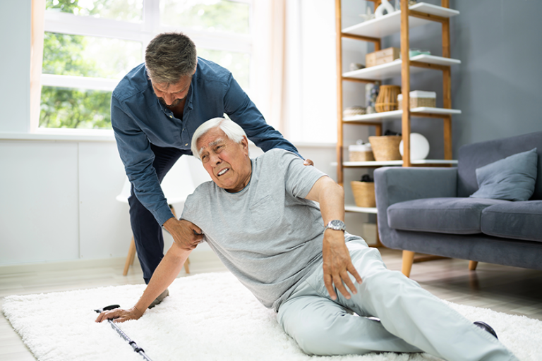 helping elder senior fallen man