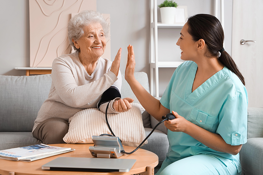 senior woman physical therapist measuring blood pressure senior woman physical therapist measuring blood pressure
