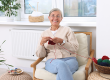 smiling senior woman knitting