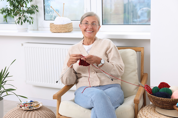smiling senior woman knitting