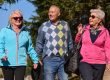 A family shares delightful moments with their friends amid the stunning landscapes of mountains, lakes, and winding paths, promoting a healthy lifestyle and the joy of familial bonds in the embrace of nature's beauty