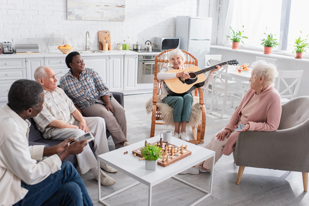 cheerful senior woman playing acoustic guitar