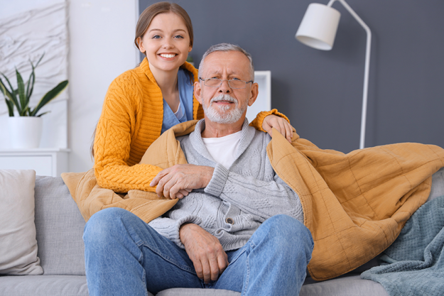 female caregiver covering senior man